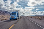 An Embark truck on a two-lane highway