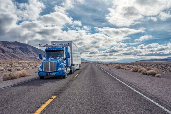 An Embark truck on a two-lane highway