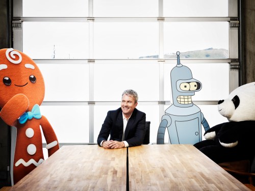 Chris DeWolfe posing with animated characters