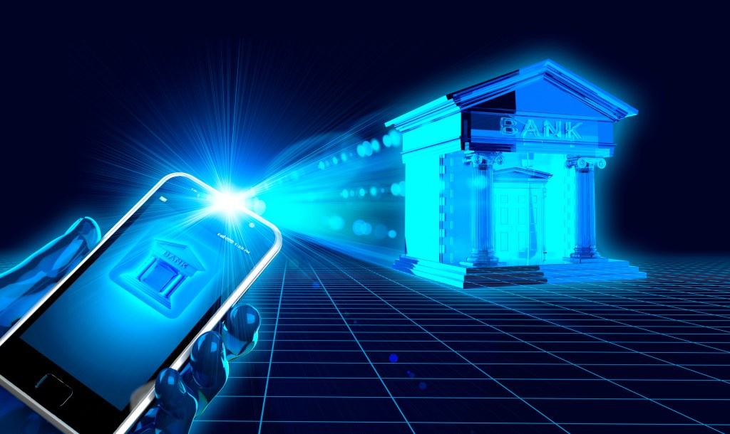 Hand using smart phone to access online banking