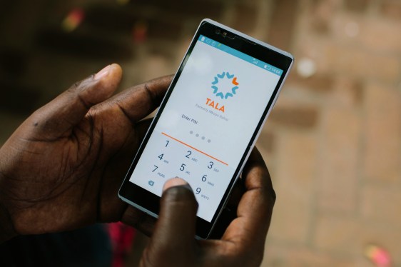 Hands holding smartphone displaying Tala app