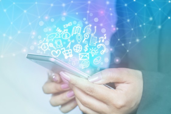 woman holding smartphone with technology icons popping out of the screen