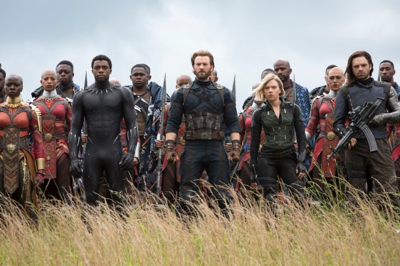 Marvel Studios' AVENGERS characters standing in field; poised for battle.