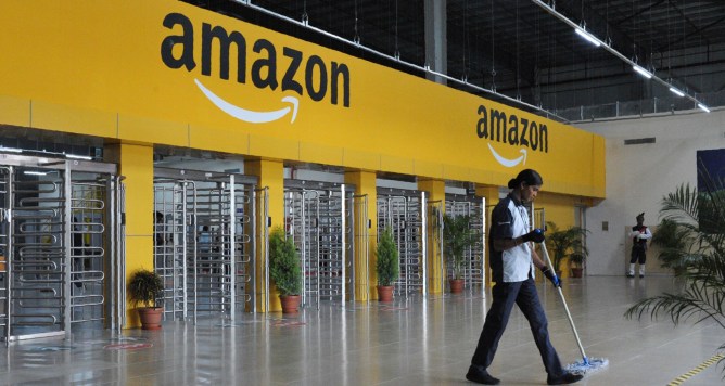 An Indian employee cleans the floor inside Amazon's largest Fulfillment Centre (FC) in India, on the outskirts of Hyderabad on September 7, 2017.