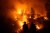 Firefighters monitor a back fire as they battle the Medocino Complex