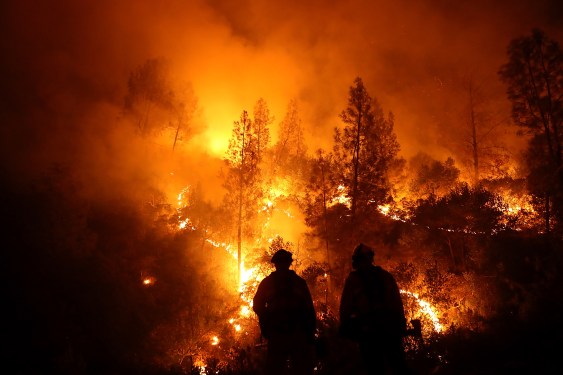 Firefighters monitor a back fire as they battle the Medocino Complex