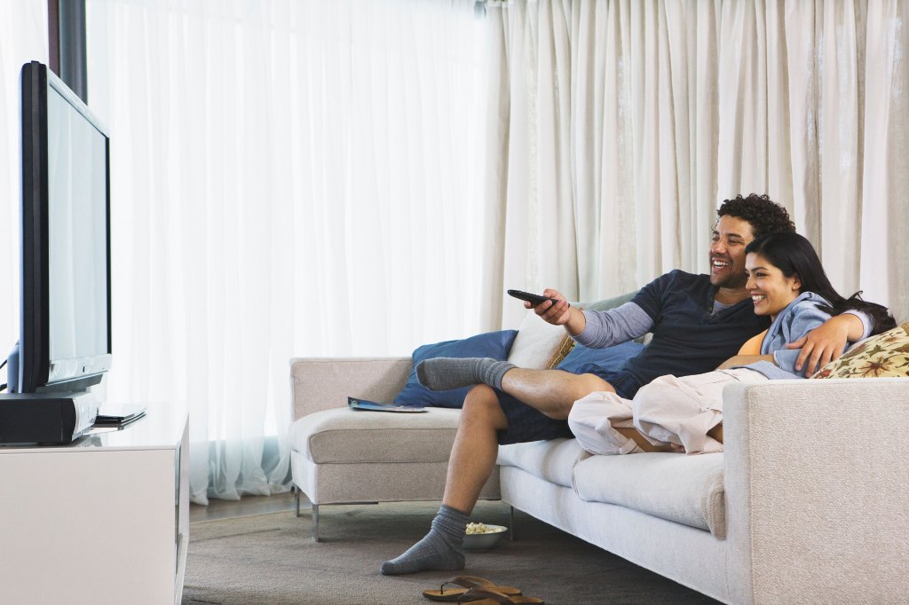 couple watching tv in their home