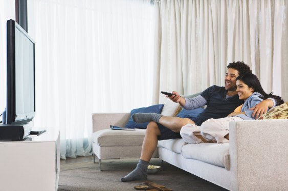 couple watching tv in their home