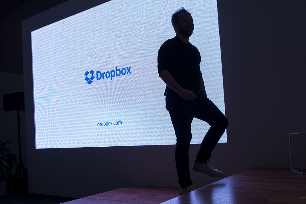 The silhouette of Drew Houston, chief executive officer and co-founder of Dropbox Inc., is seen walking on stage during an event in San Francisco, California, U.S., on Monday, Jan. 30, 2017. Dropbox announced today that they are releasing Smart Sync, a tool which lets users access terabytes of data without downloading it to their desktop so the information can be viewed on laptops with limited memory. Photographer: David Paul Morris/Bloomberg via Getty Images