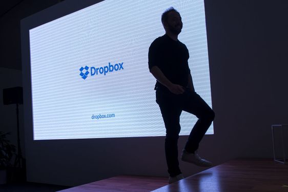 The silhouette of Drew Houston, chief executive officer and co-founder of Dropbox Inc., is seen walking on stage during an event in San Francisco, California, U.S., on Monday, Jan. 30, 2017. Dropbox announced today that they are releasing Smart Sync, a tool which lets users access terabytes of data without downloading it to their desktop so the information can be viewed on laptops with limited memory. Photographer: David Paul Morris/Bloomberg via Getty Images