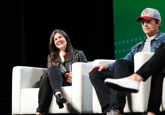 Ashton Kutcher and Effie Epstein onstage at TechCrunch Disrupt