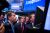 Steven Birdsall, chief revenue officer of Anaplan Inc., left, and Frank Calderoni, president and chief executive officer of Anaplan Inc., center, talk to a trader during the company's initial public offering (IPO) on the floor of the New York Stock Exchange (NYSE) in New York, U.S., on Friday, Oct. 12, 2018. U.S. stocks surged Friday after two days of market tumult as trade tensions with China seemed to ease, at least temporarily, with the countries planning to meet in November and the Treasury Department saying that China isn't manipulating its currency. Photographer: Michael Nagle/Bloomberg via Getty Images
