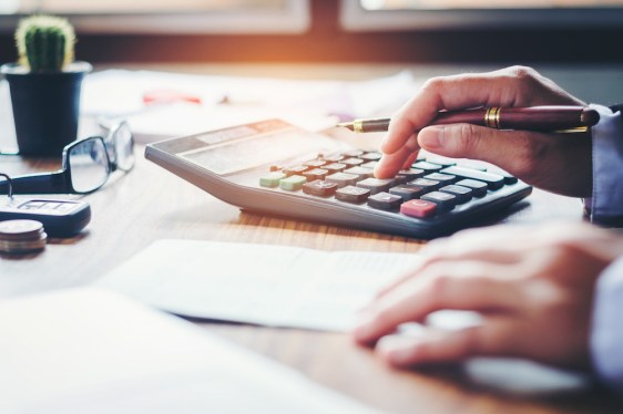 Businessman's hands with calculator at the office