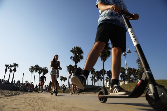 People ride Bird shared dockless electric scooters