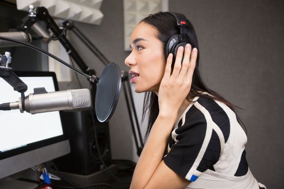 podcaster speaking into microphone