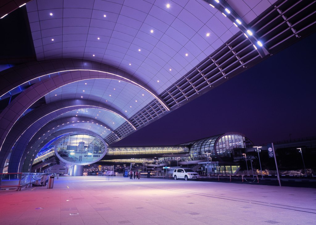 Illuminated Dubai International Airport at dusk, UAE