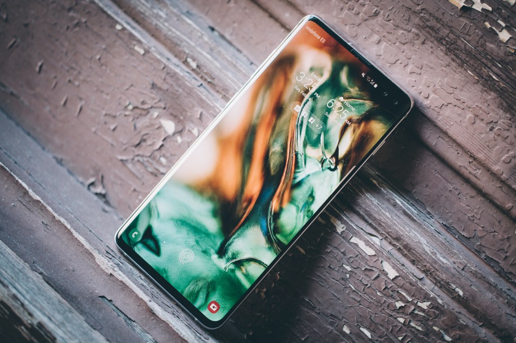 A Samsung phone on a wooden table.