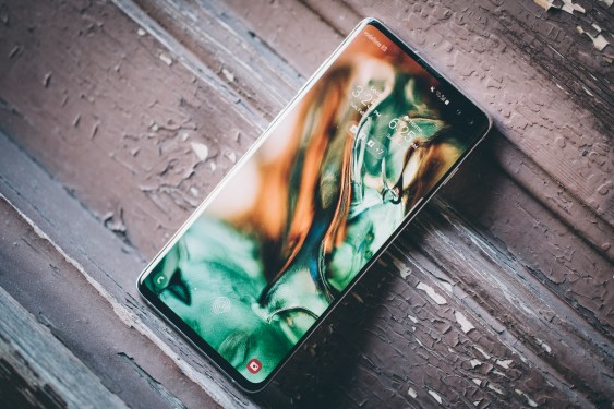 A Samsung phone on a wooden table.
