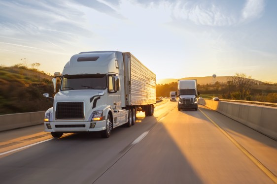 freight semi truck 18 wheeler sunrise on highway