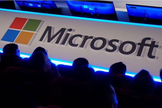 International buyers listen to a speech in front of a Microsoft logo during the Computex tech show in Taipei on June 4, 2014. More than 1,500 exhibitors, including some of the world's leading technology brands, will set out their stalls at Computex in the capital, with 130,000 visitors expected for the five-day event. AFP PHOTO / SAM YEH (Photo credit should read SAM YEH/AFP/Getty Images)