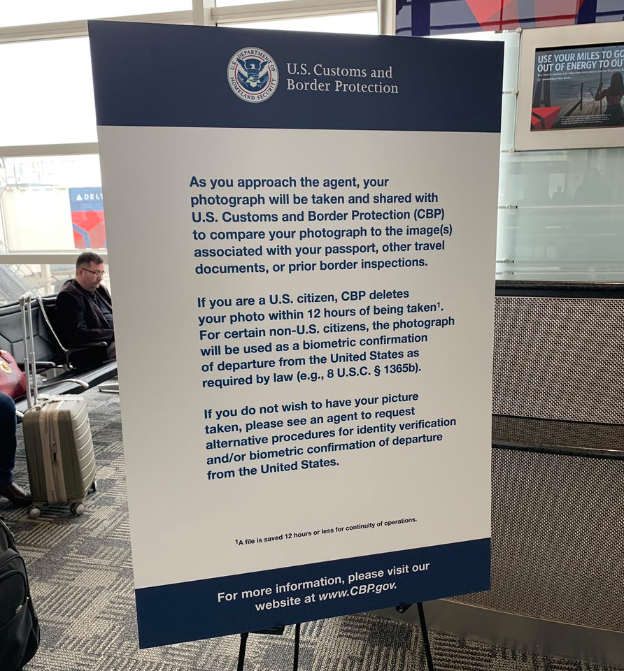 a sign at a U.S. airport telling passengers that they are about to have their faces scanned, and the protocol for opting out