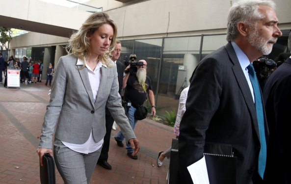 Elizabeth Holmes walks into court