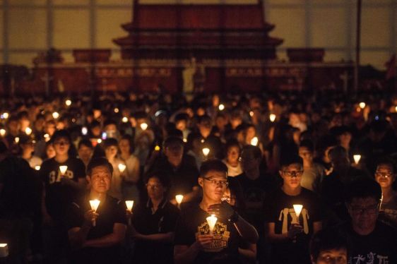 People hold candles during a vigil in Hong Kong on June 4, 2018, to mark the 29th anniversary of the 1989 Tiananmen crackdown in Beijing. - Crowds assembled in Hong Kong on June 5 in memory of the victims of China's Tiananmen Square crackdown but young activists are increasingly questioning the annual vigil's relevance. Semi-autonomous Hong Kong has seen tens of thousands gather at the candlelit vigil in Victoria Park since 1990, while any mention of Beijing's brutal crackdown on students calling for democracy on June 4, 1989, remains strictly censored in the mainland. (Photo by Anthony WALLACE / AFP) (Photo credit should read ANTHONY WALLACE/AFP/Getty Images)