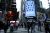NEW YORK, NY - APRIL 18: People pass walk by the Nasdaq building as the screen shows the logo of the video-conferencing software company Zoom after the opening bell ceremony on April 18, 2019 in New York City. The video-conferencing software company announced it's IPO priced at $36 per share, at an estimated value of $9.2 billion. (Photo by Kena Betancur/Getty Images)