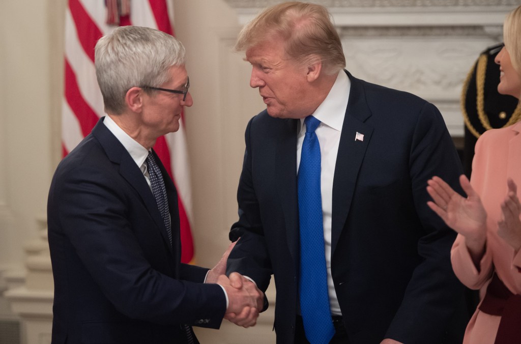 US President Donald Trump shakes hands with Apple CEO Tim Cook