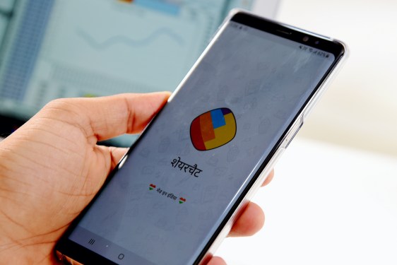 hand holding smartphone displaying sharechat