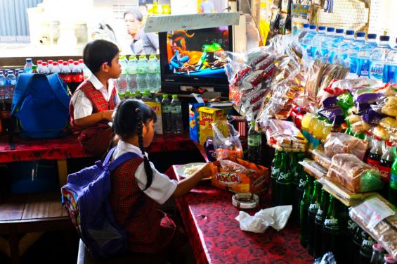 Children of a 'warung' local café have their breakfast