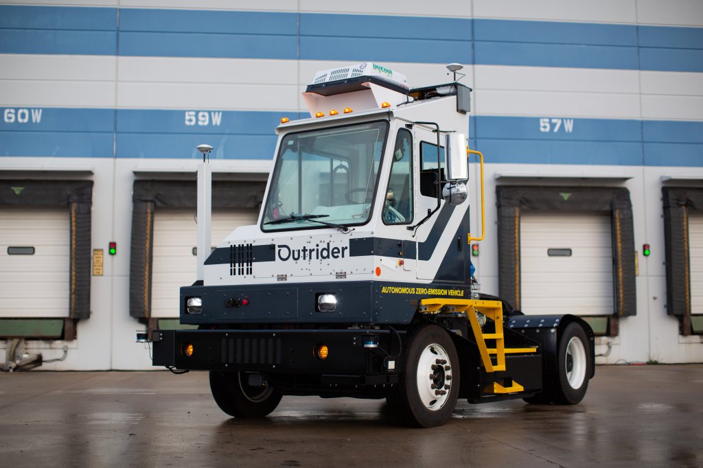 electric yard truck in front of warehouse bay doors