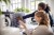 Businesswoman discussing with female colleague over coding on computer at desk in creative office