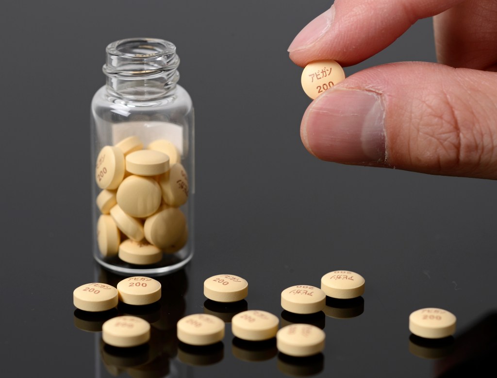 bottle of pills, some spilled on counter