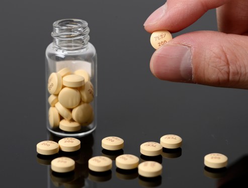 bottle of pills, some spilled on counter