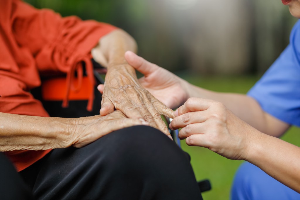 elderly woman talking with caregiver