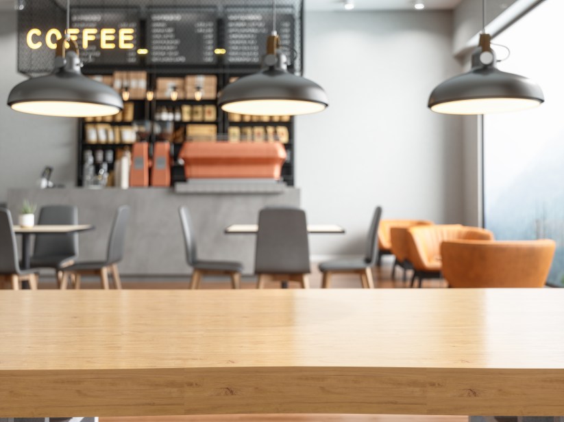 Empty wooden table top with blur coffee shop