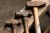 Three types of hammers sit on a wood bench