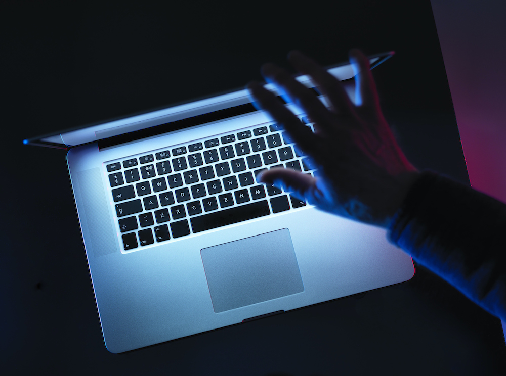 Hacking, man opening laptop computer
