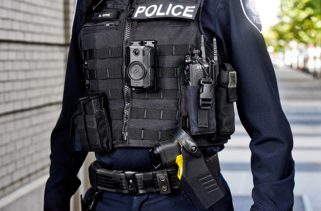 A police officer with body camera and Taser.