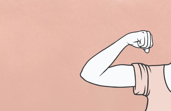 Woman flexing biceps muscle