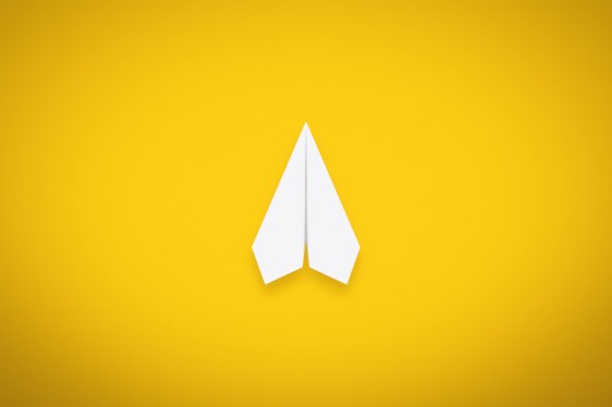 A Single Paper Airplane on Yellow Background