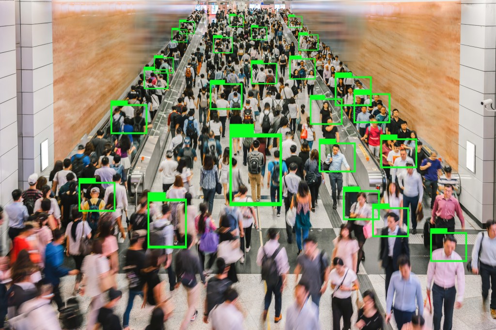 Artificial Intelligence for Deep Learning Technology over Top view scene of Motion blurred Crowd unrecognizable pedestrians walking internal subway intersection in rush hour before working hour, central Hong Kong.