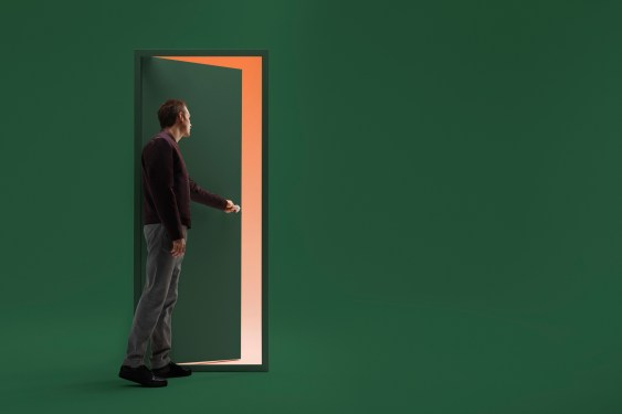 Man opening door in futuristic room