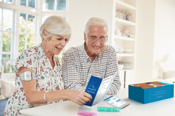 A publicity photo of patients using digital therapeutics startup Biofourmis' Biovitals system