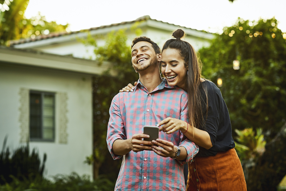 Cheerful couple looking at smart phone. Young man and woman are wearing casuals. They are having fun in back yard (Cheerful couple looking at smart phone. Young man and woman are wearing casuals. They are having fun in back yard, ASCII, 114 components