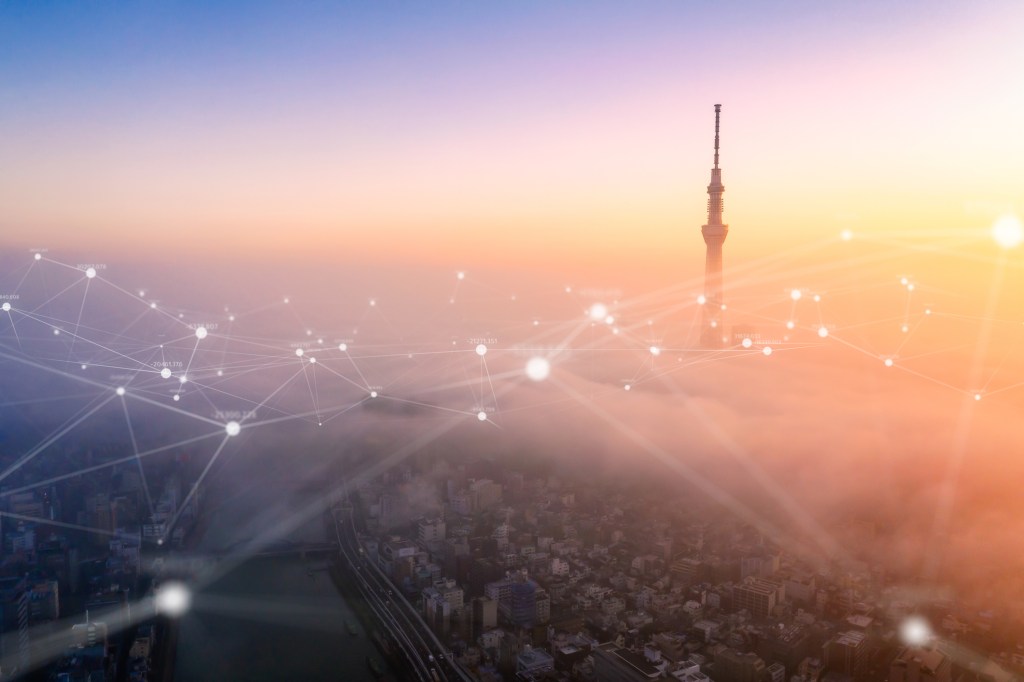 Digital illustration of an aerial view of Tokyo city with networking connections lines