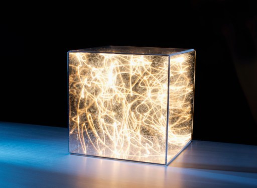 Trails of bright light and sparks trapped in clear box