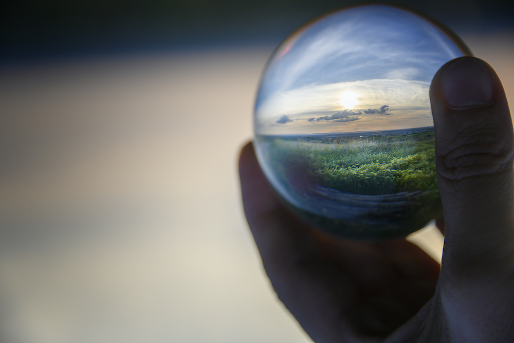 Dreamy landscape in handheld lensball (Original Title: "Preservation")