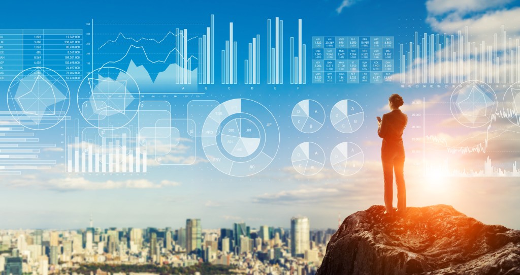 Businessperson standing on the mountain top. Strategy of business concept.